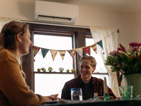 two people talking at dining room table