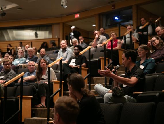 person speaking in auditorium